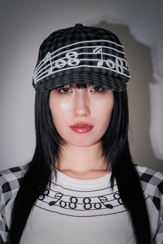 Embroidery of music note on plaid fabric Cap